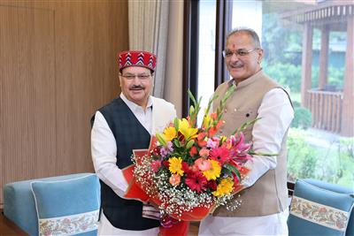 Jagat Prakash Nadda in a red-bordered Himachali cap receiving a bouquet