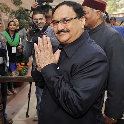 Jagat Prakash Nadda with hands folded in greeting, photographers behind him
