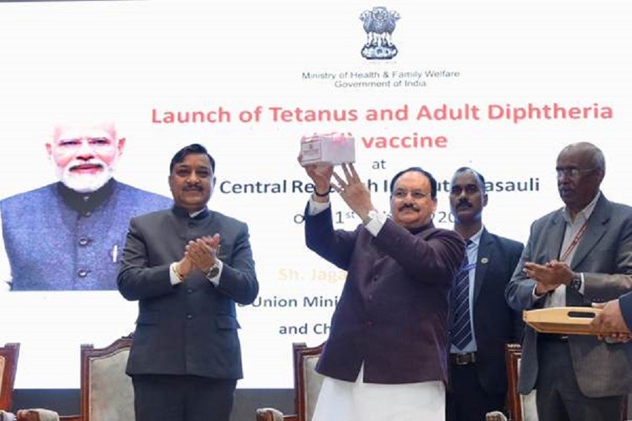 Jagat Prakash Nadda holding up a vaccine pack on stage in front of a screen reading Launch of Tetanus and Adult Diphtheria vaccine