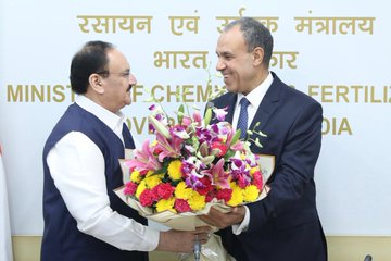 Jagat Prakash Nadda receiving a bouquet beneath a sign reading Ministry of Chemicals and Fertilizers