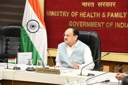 Jagat Prakash Nadda seated at a meeting table beneath a sign reading Ministry of Health and Family Welfare
