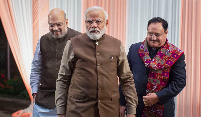 Narendra Modi walking in front, with Amit Shah and Jagat Prakash Nadda behind him