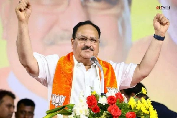 Jagat Prakash Nadda at a lectern with both arms raised